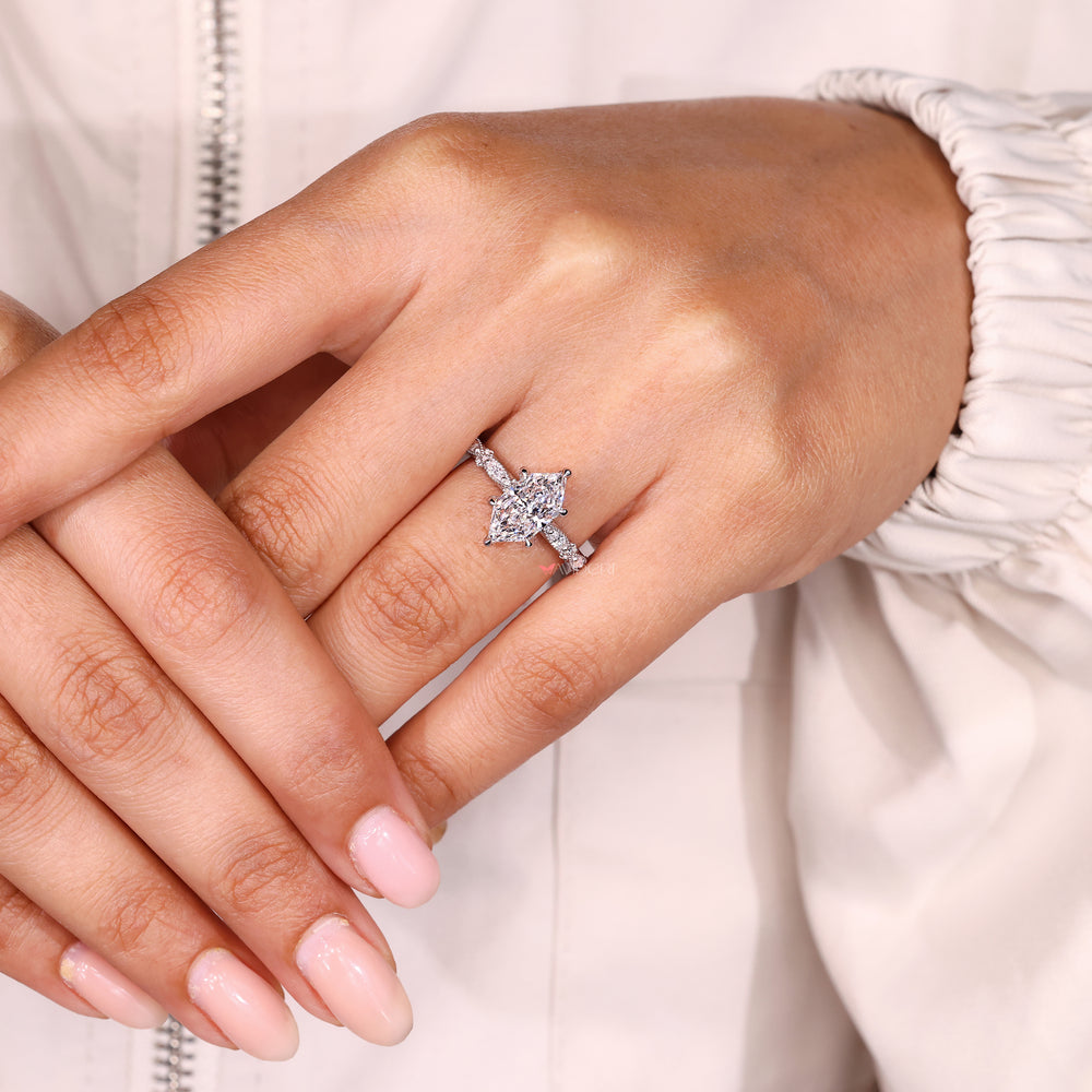 Handmade lab diamond ring with marquise and round stones.
