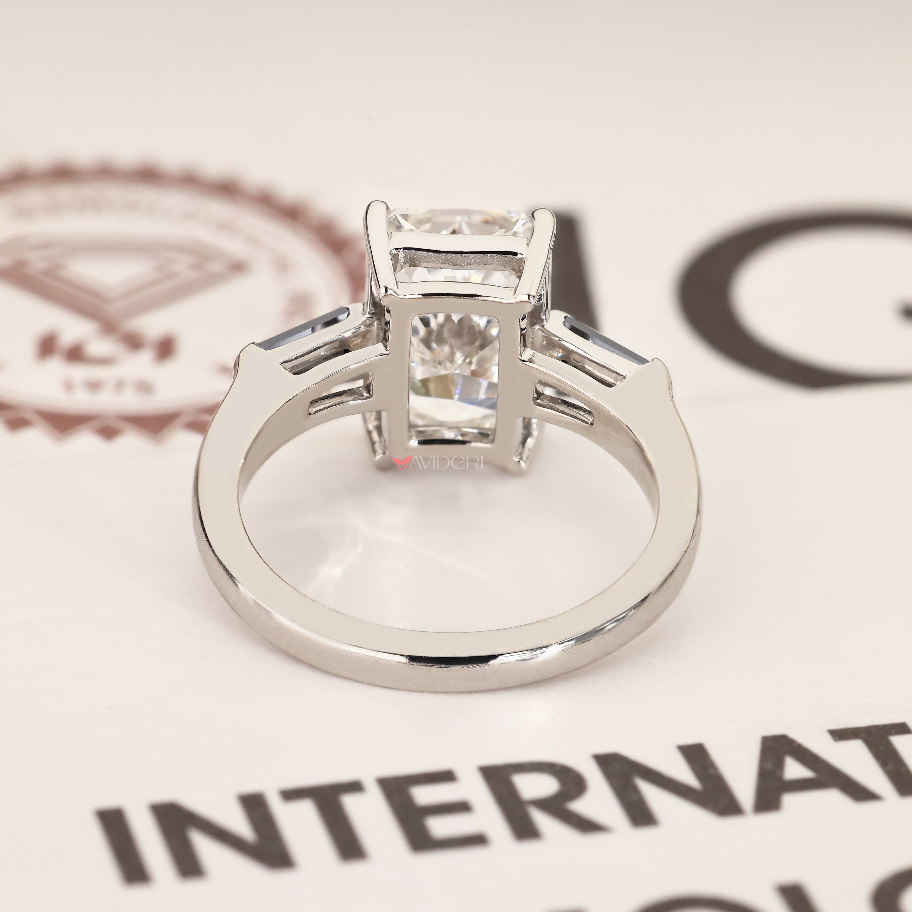 Three stone ring with radiant centre diamond.
