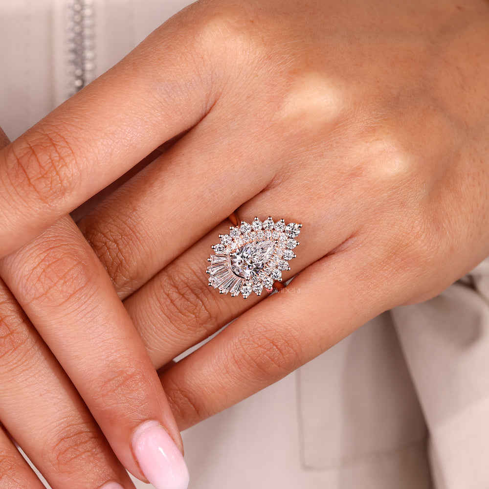 Pear cut diamond ring featuring cluster halo and cathedral setting.