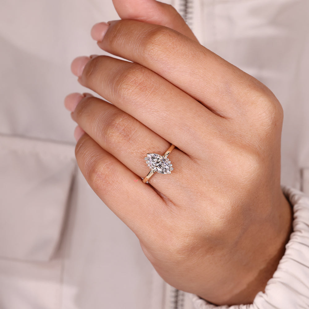 Marquise diamond ring with detailed milgrain edge.
