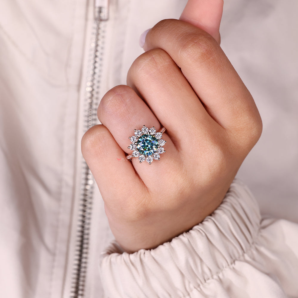 Moissanite ring with round cut cyan blue stones.
