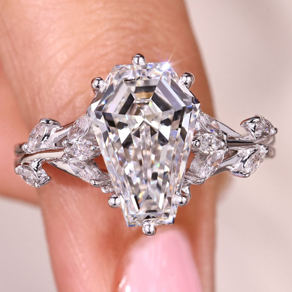 Coffin cut diamond engagement ring with marquise side stones.
