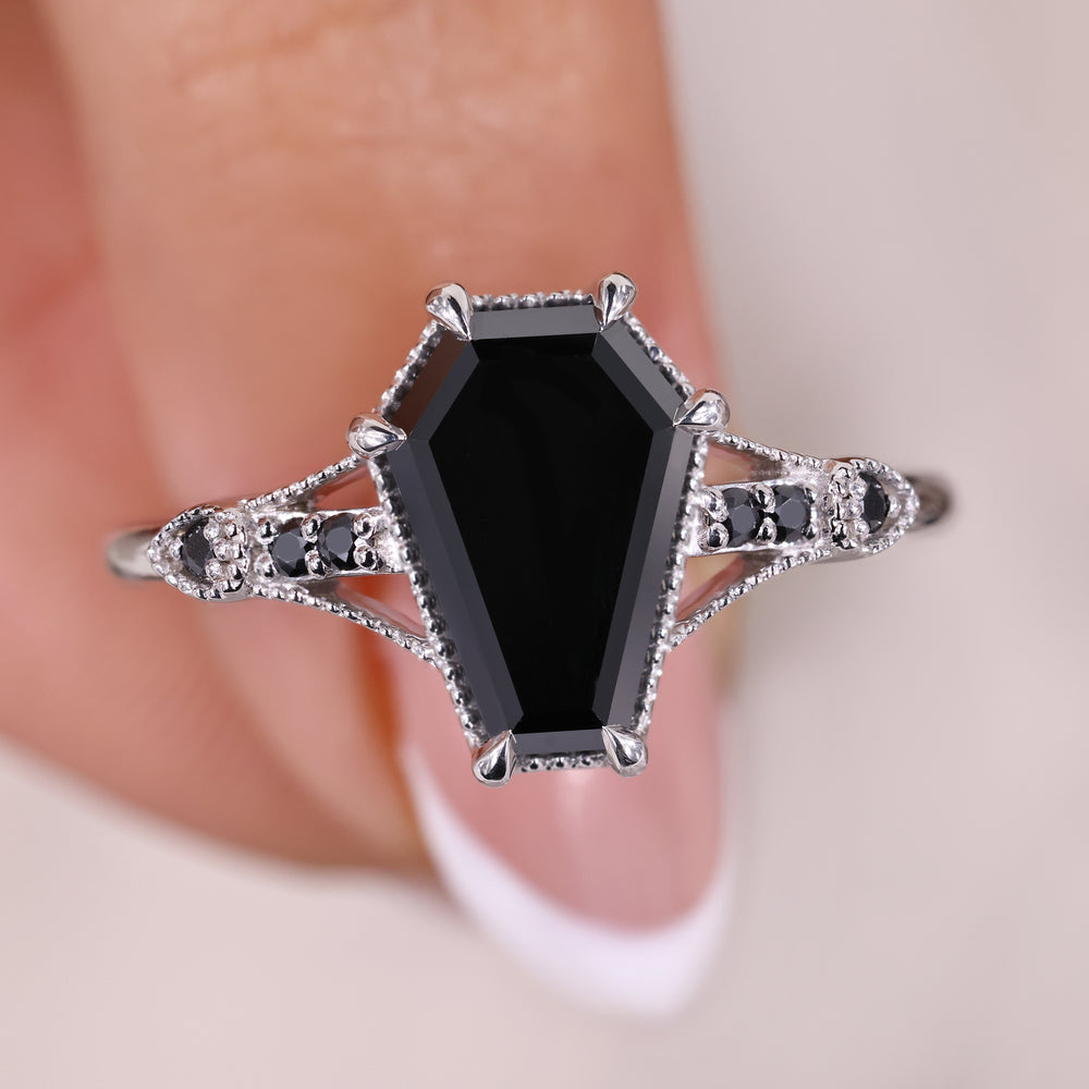Coffin cut engagement ring with round cut side stones.