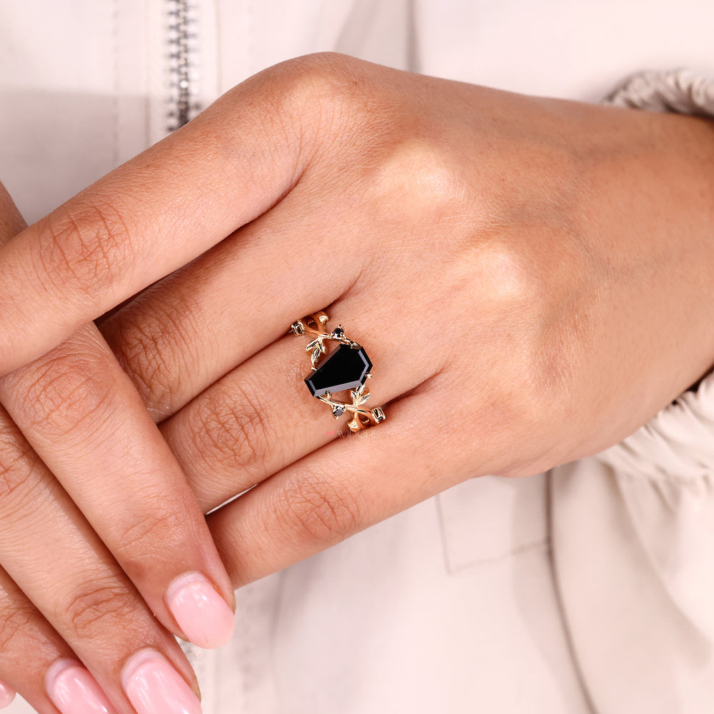 Moissanite engagement ring with a dramatic coffin cut center.