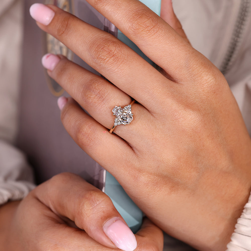 Coffin cut center seven stone diamond ring with round sides.