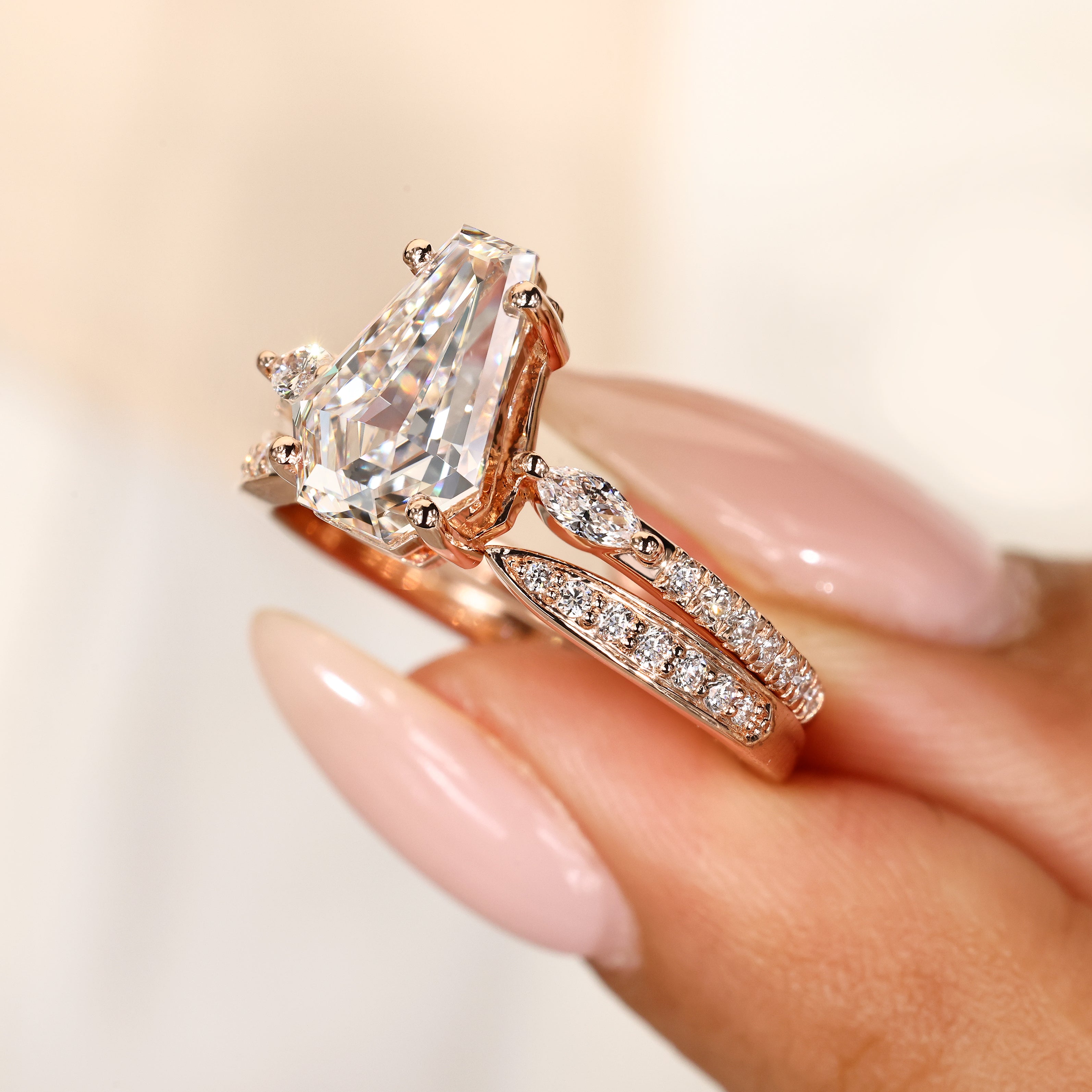 Marquise side stone coffin diamond engagement ring.
