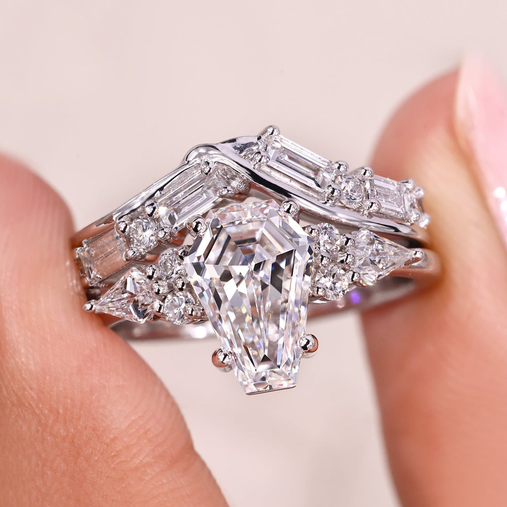 Coffin cut engagement ring with kite cut side stones.