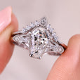 Coffin cut engagement ring with round side stones.