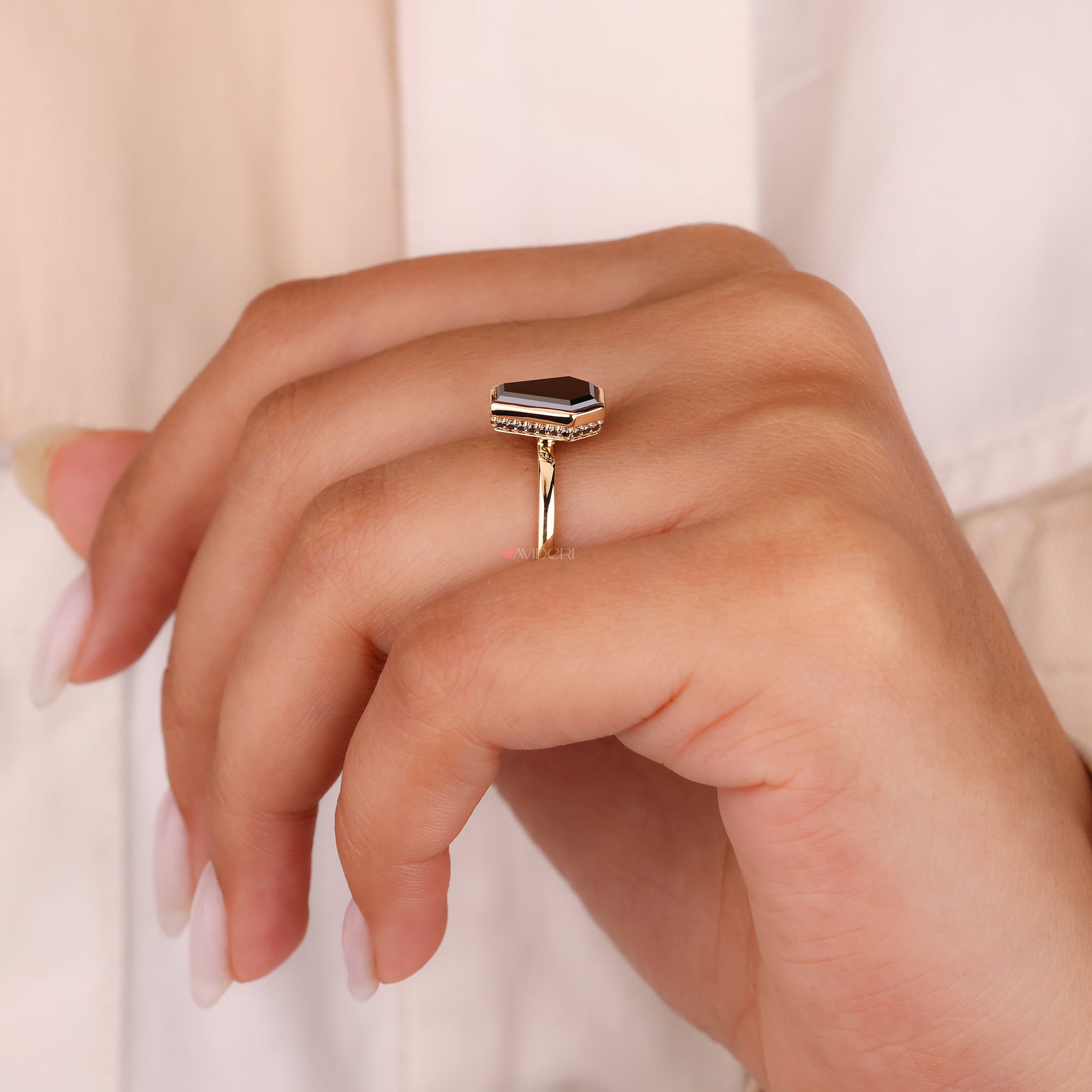 Unconventional style is captured by the coffin cut engagement ring.

