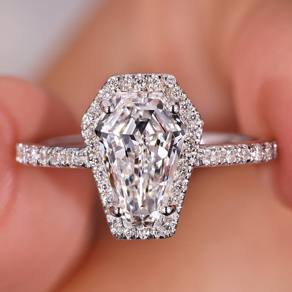 Coffin engagement ring with pave setting and round cut diamond.