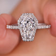 Coffin engagement ring with pave setting and round cut diamond.