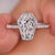 Coffin engagement ring with pave setting and round cut diamond.