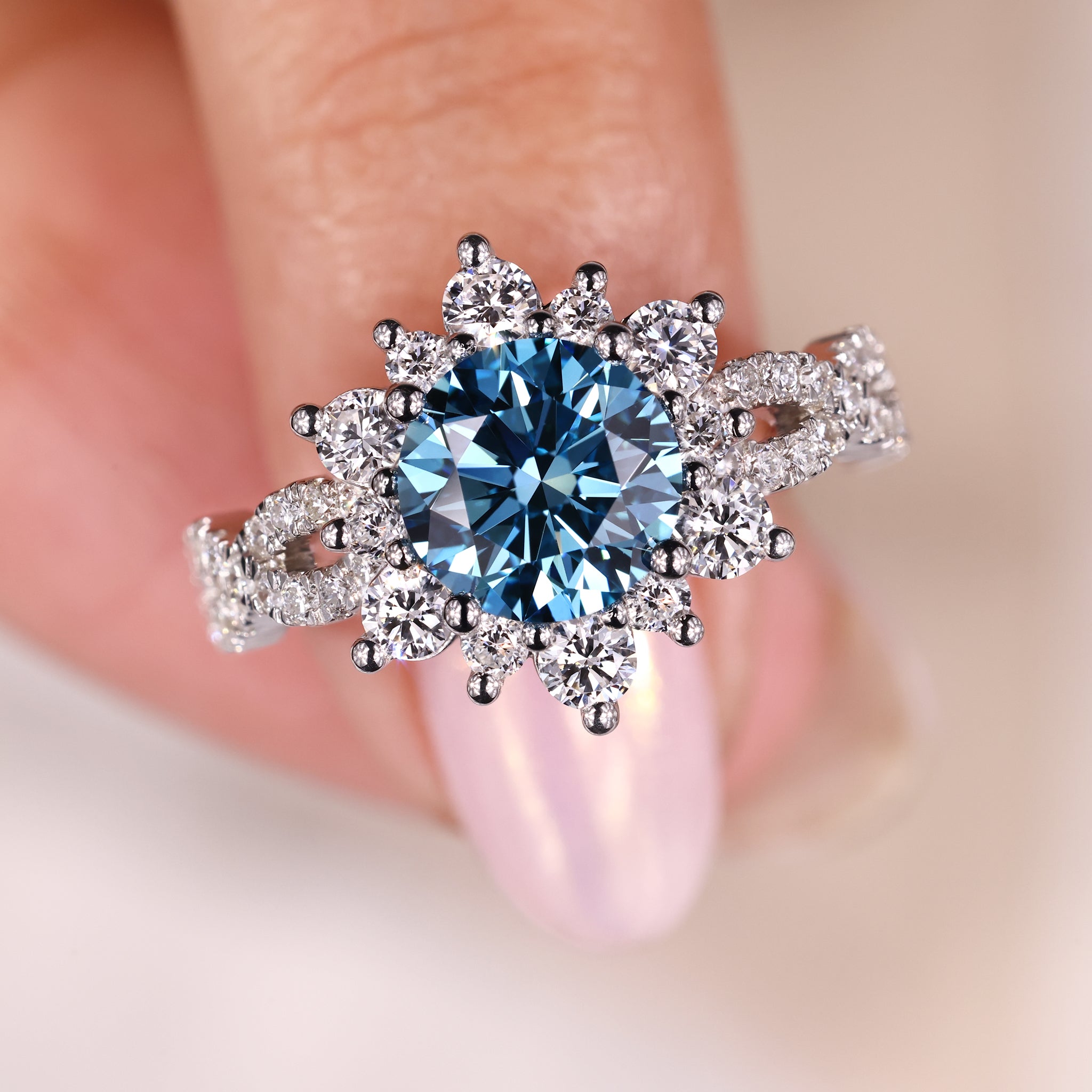 round blue diamond cluster engagement ring with prong setting and custom band.