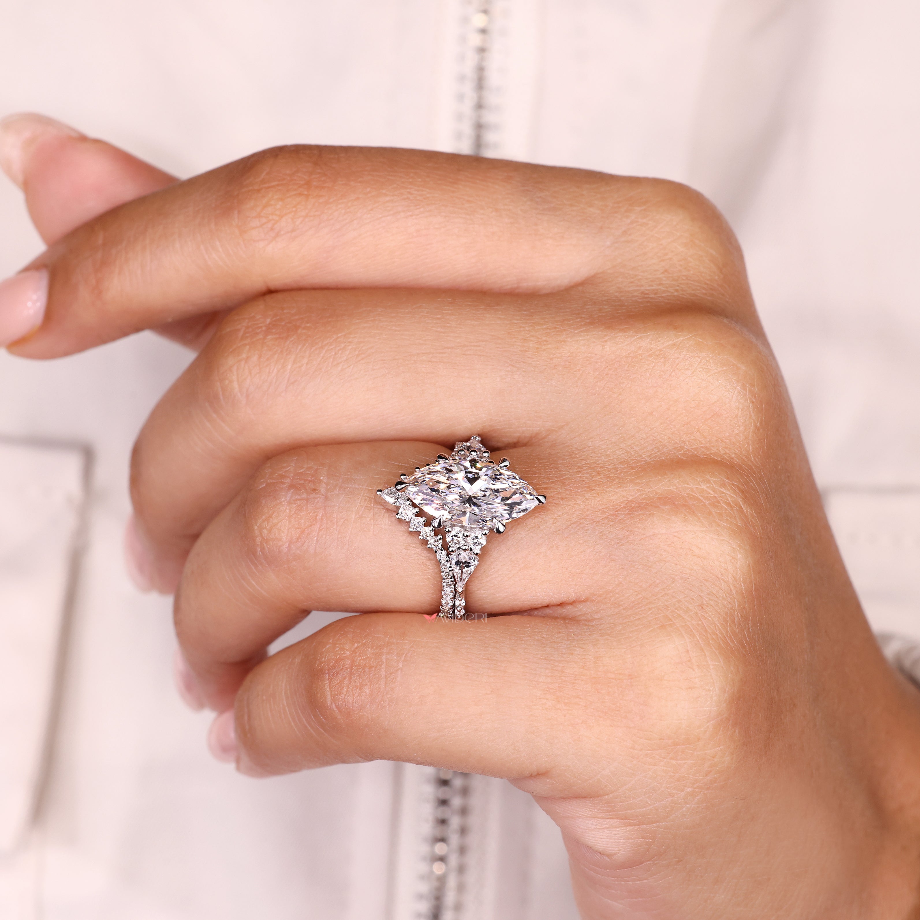 Half eternity curved band with marquise ring.
