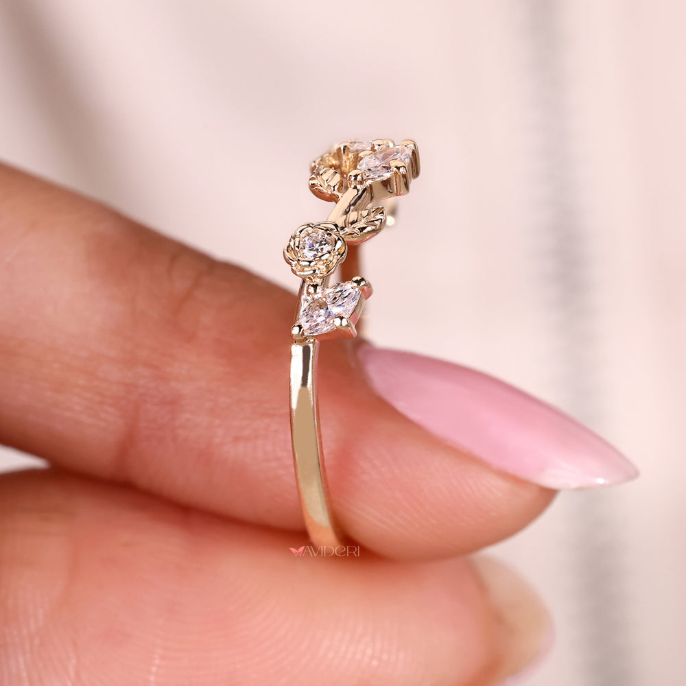 Nature inspired diamond wedding band with marquise and round accents.
