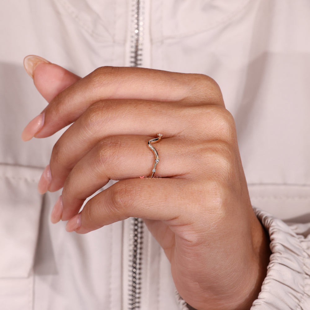 Curved diamond wedding band with four stones.
