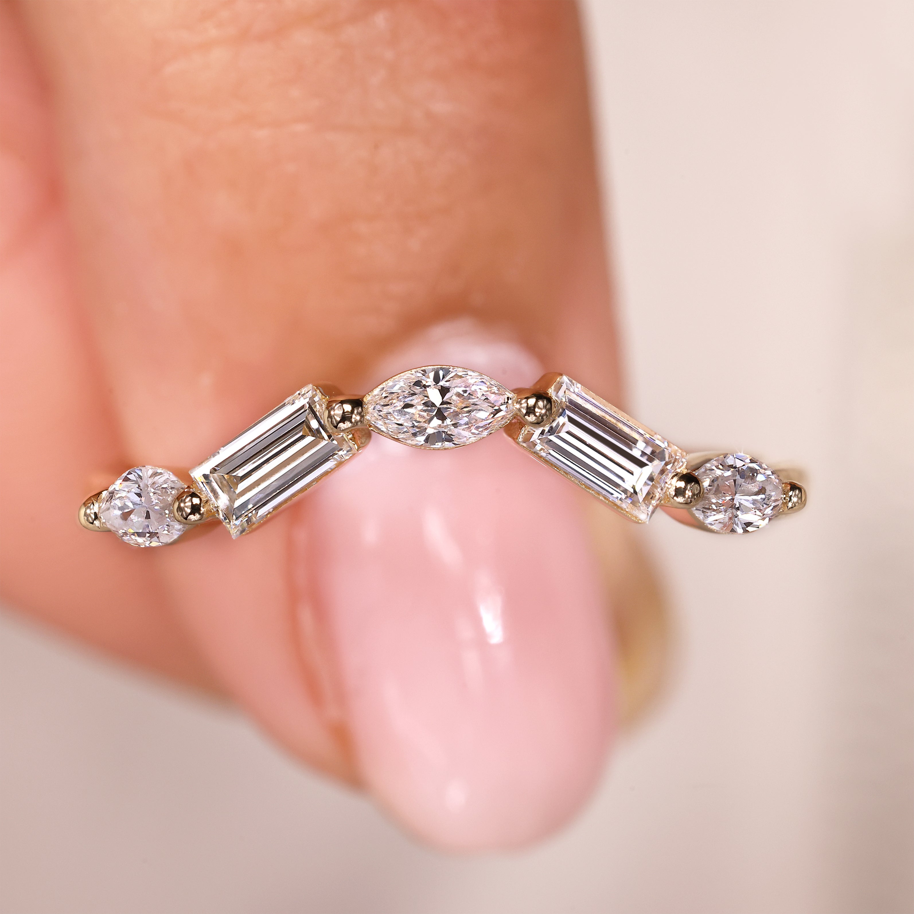 Curved wedding band with marquise and baguette diamonds.
