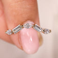 Curved wedding band with marquise and baguette diamonds.
