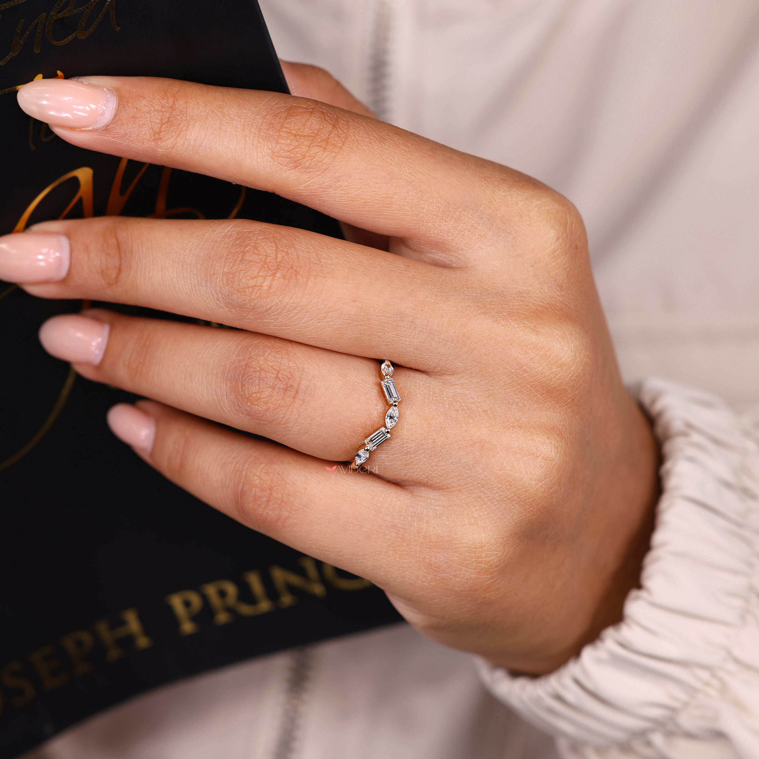 Half eternity band with marquise and baguette stone design.
