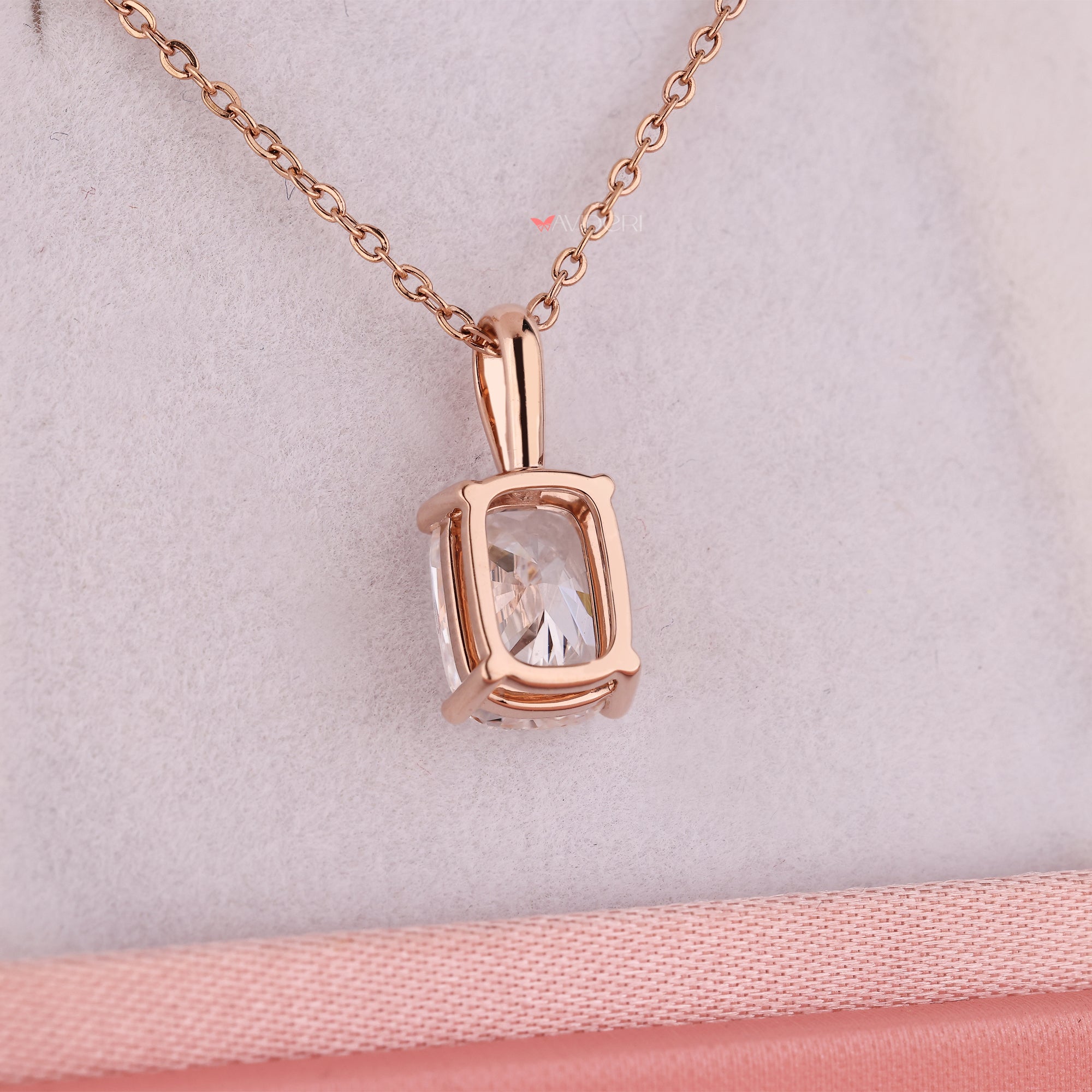 Rose gold pendant with cushion cut diamond in claw prong design.