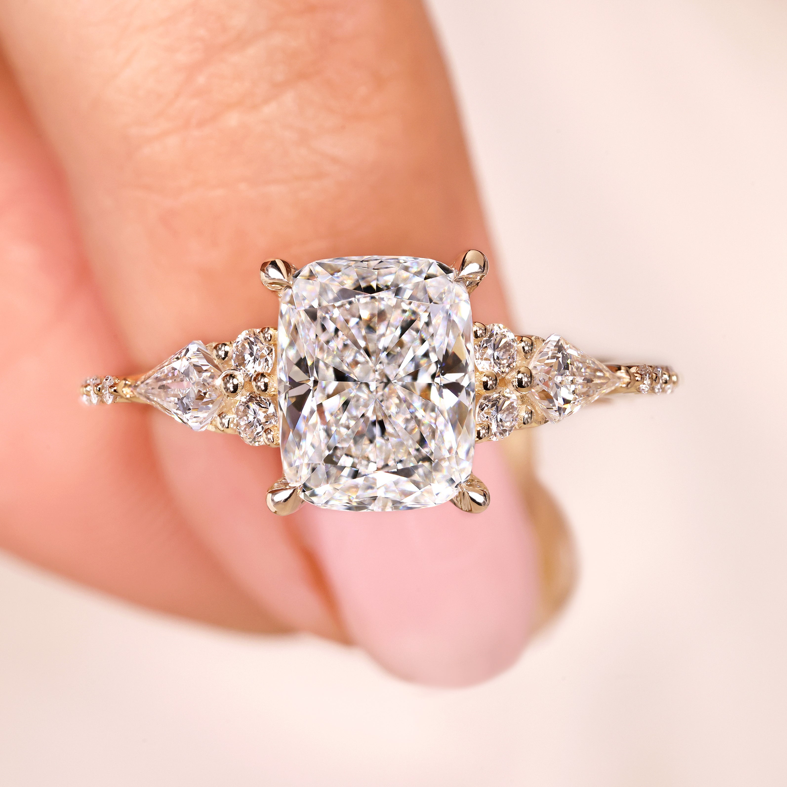 Cushion cut lab grown diamond ring with kite side stones.
