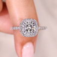 Cushion cut diamond ring with halo and pave style.
