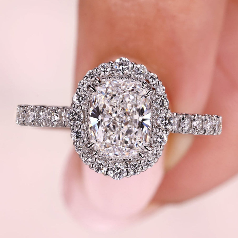 Cushion diamond engagement ring with double claw prong.