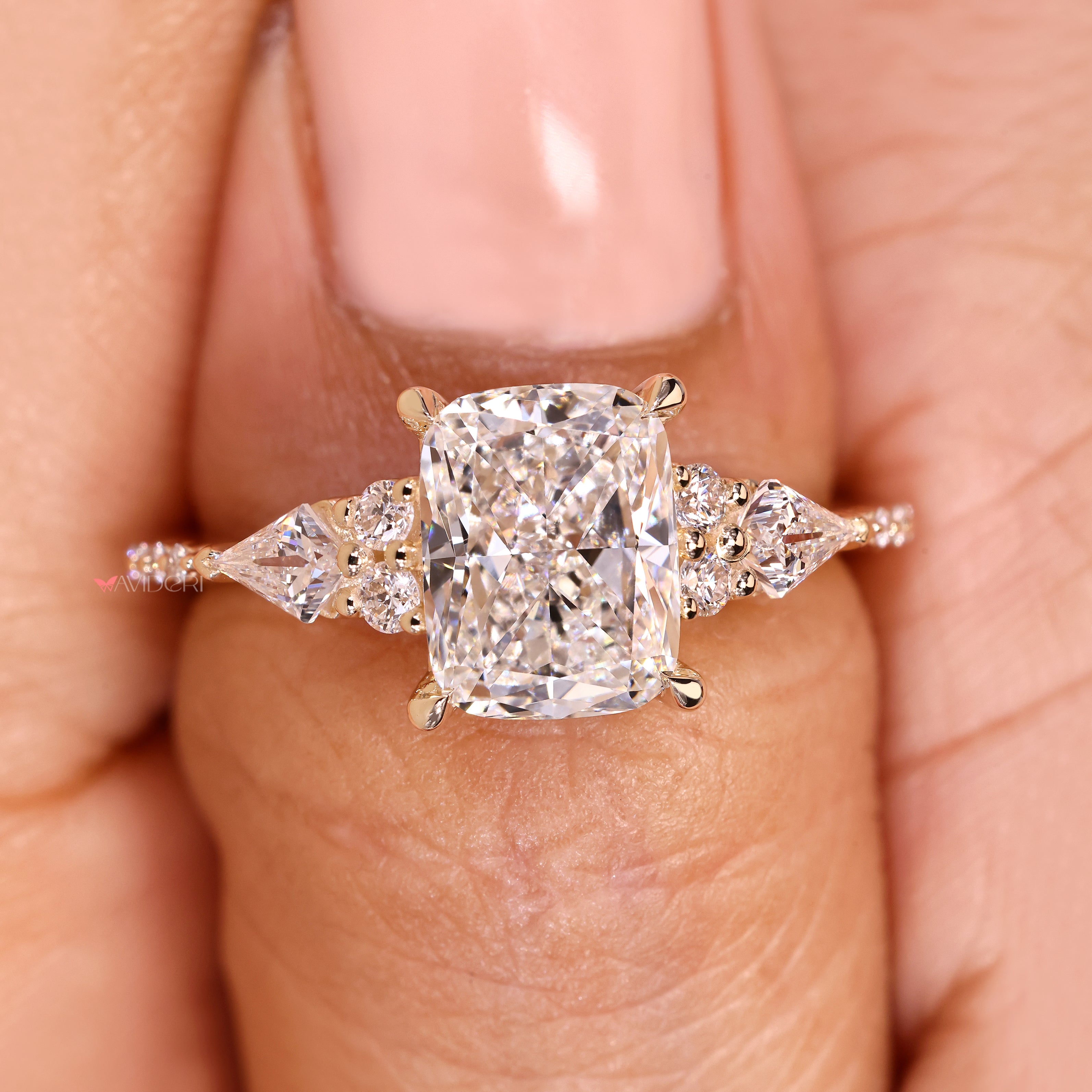 Cushion cut diamond ring with detailed side stone accents.
