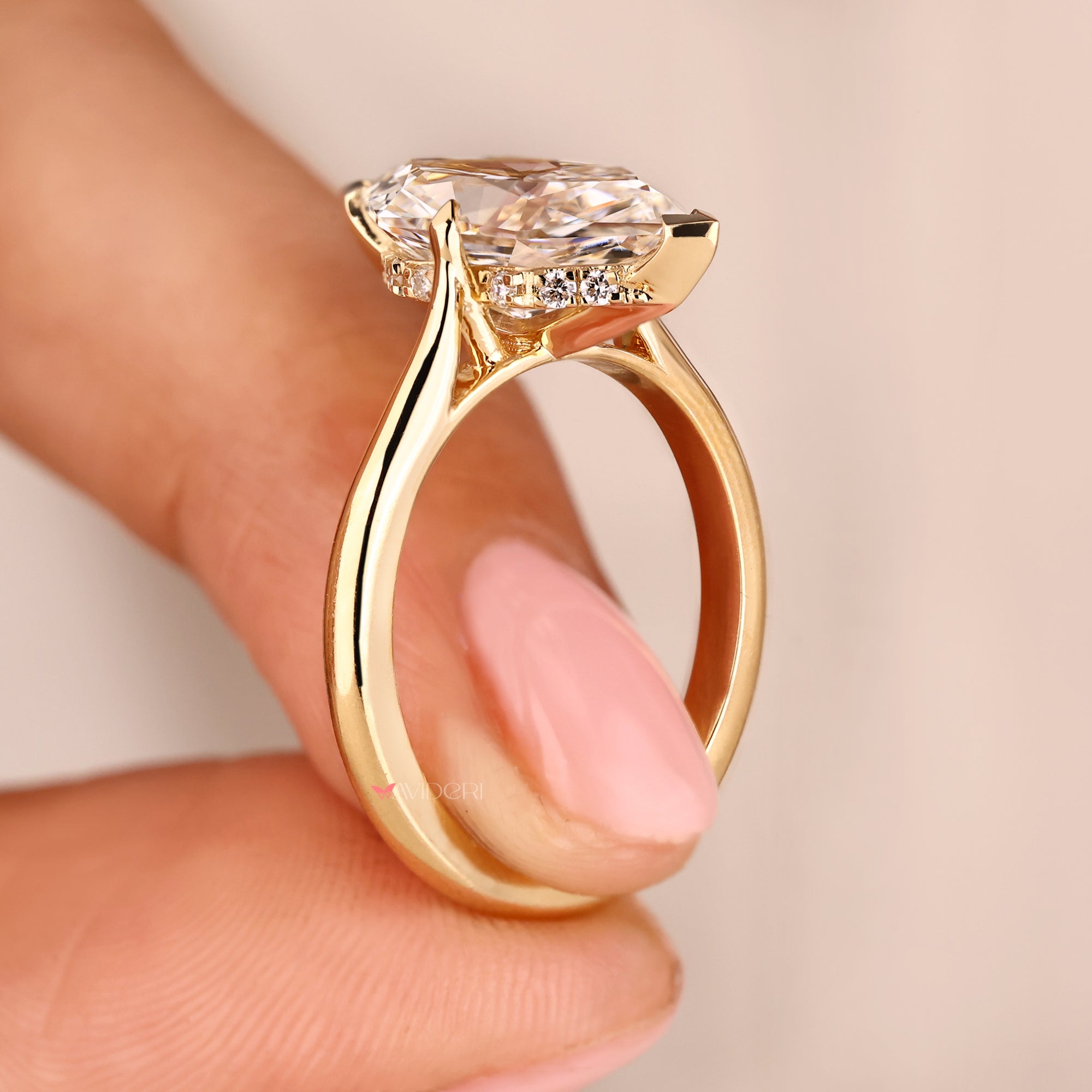 Hidden halo diamond ring designed in yellow gold with handmade detailing.