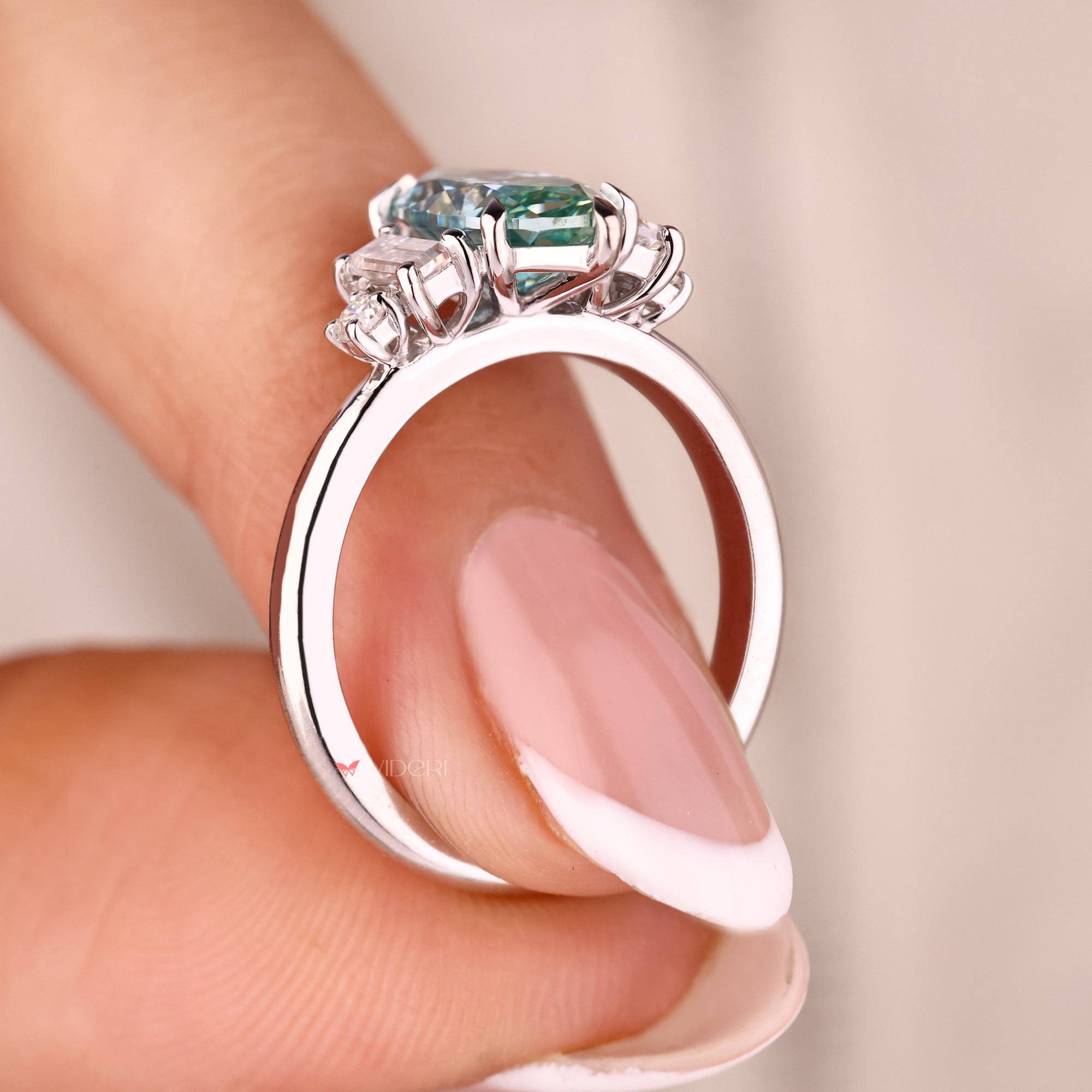 White gold engagement ring with marquise cyan blue ring.