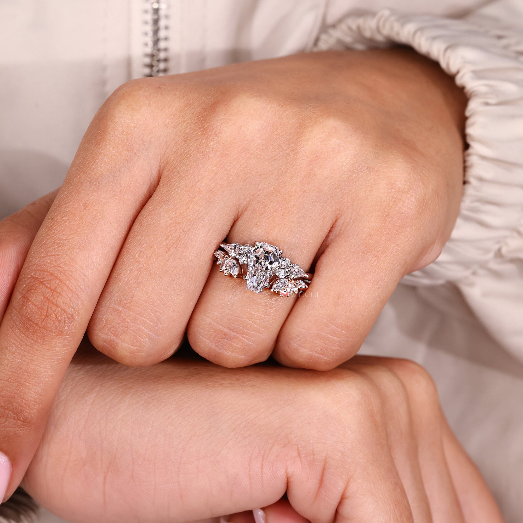 Close-up of a hand wearing a diamond ring with a soft background
