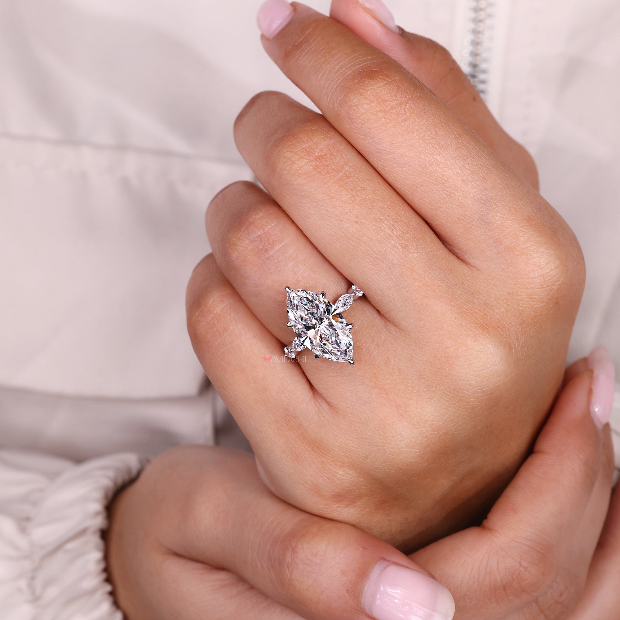 Six claw prong setting ring with marquise cut diamond.