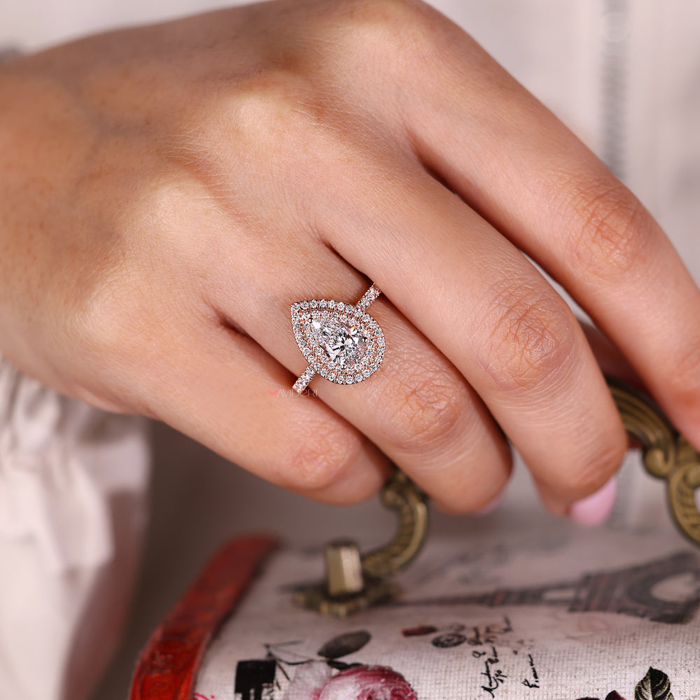 Round halo diamond ring in soft rose gold tone.