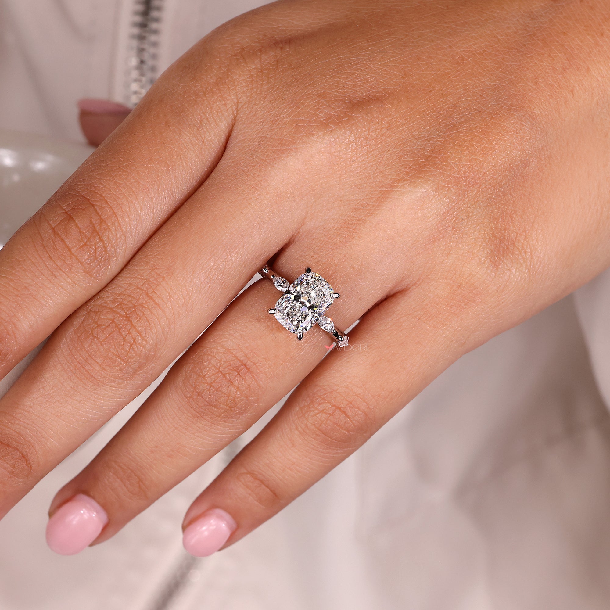 Four prong setting ring featuring an elongated cushion diamond.