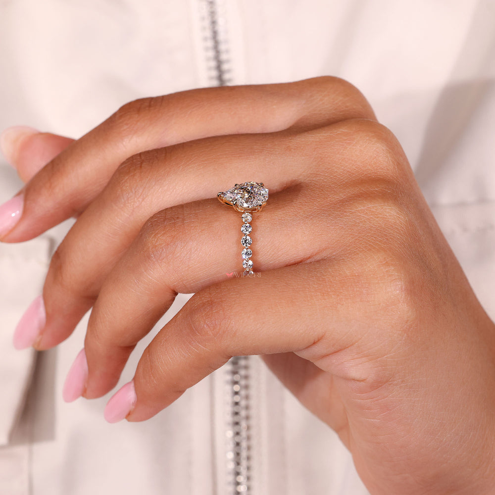 Shared prong diamond ring with a yellow gold band.