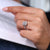 Halo diamond ring with radiant cut center and pave band.
