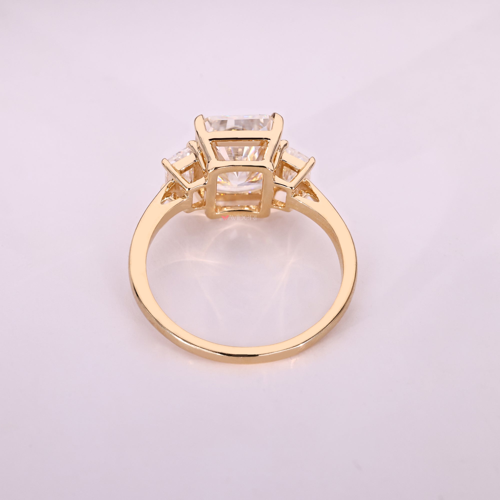 Moissanite engagement ring with radiant center stone.