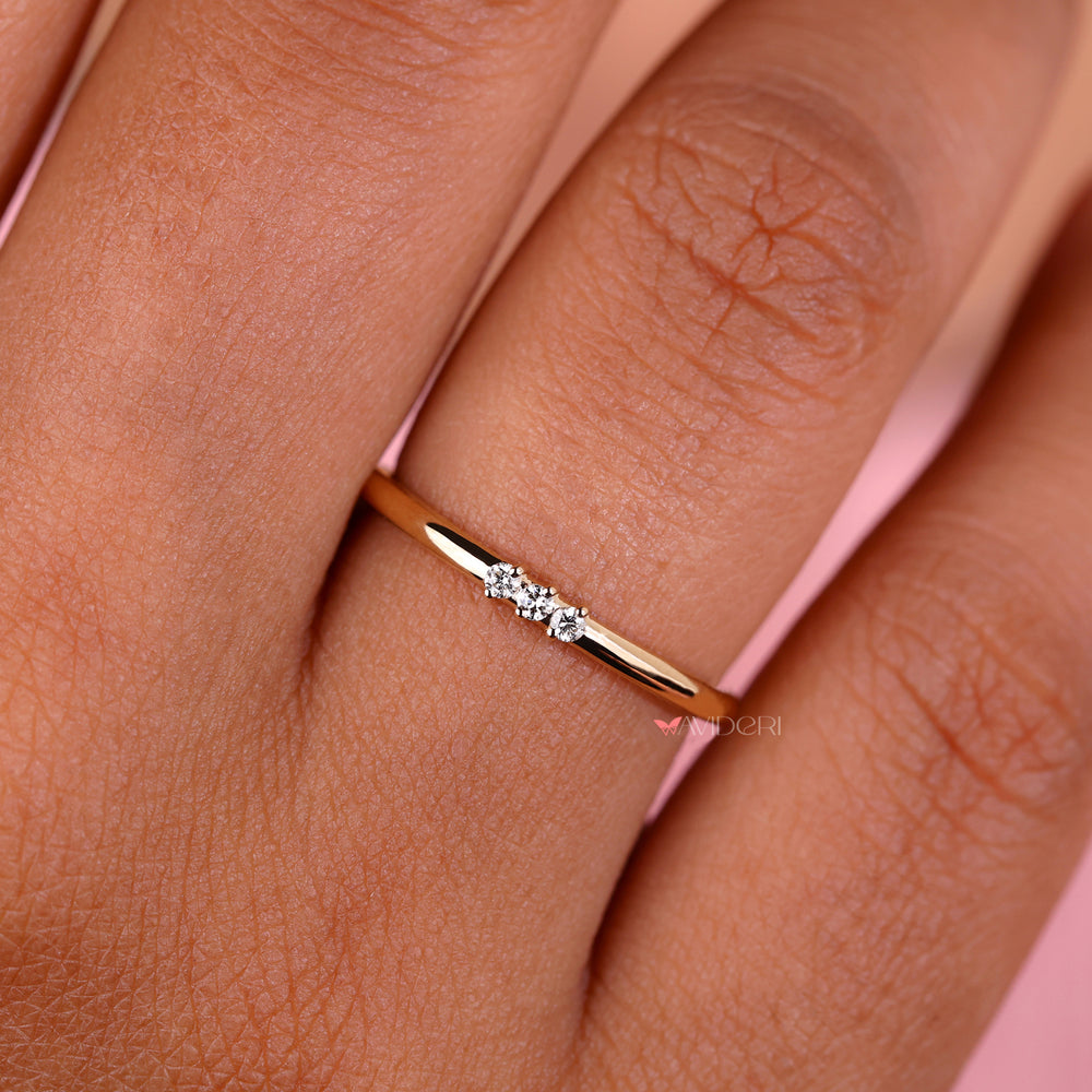 3 stone diamond wedding band with delicate details.
