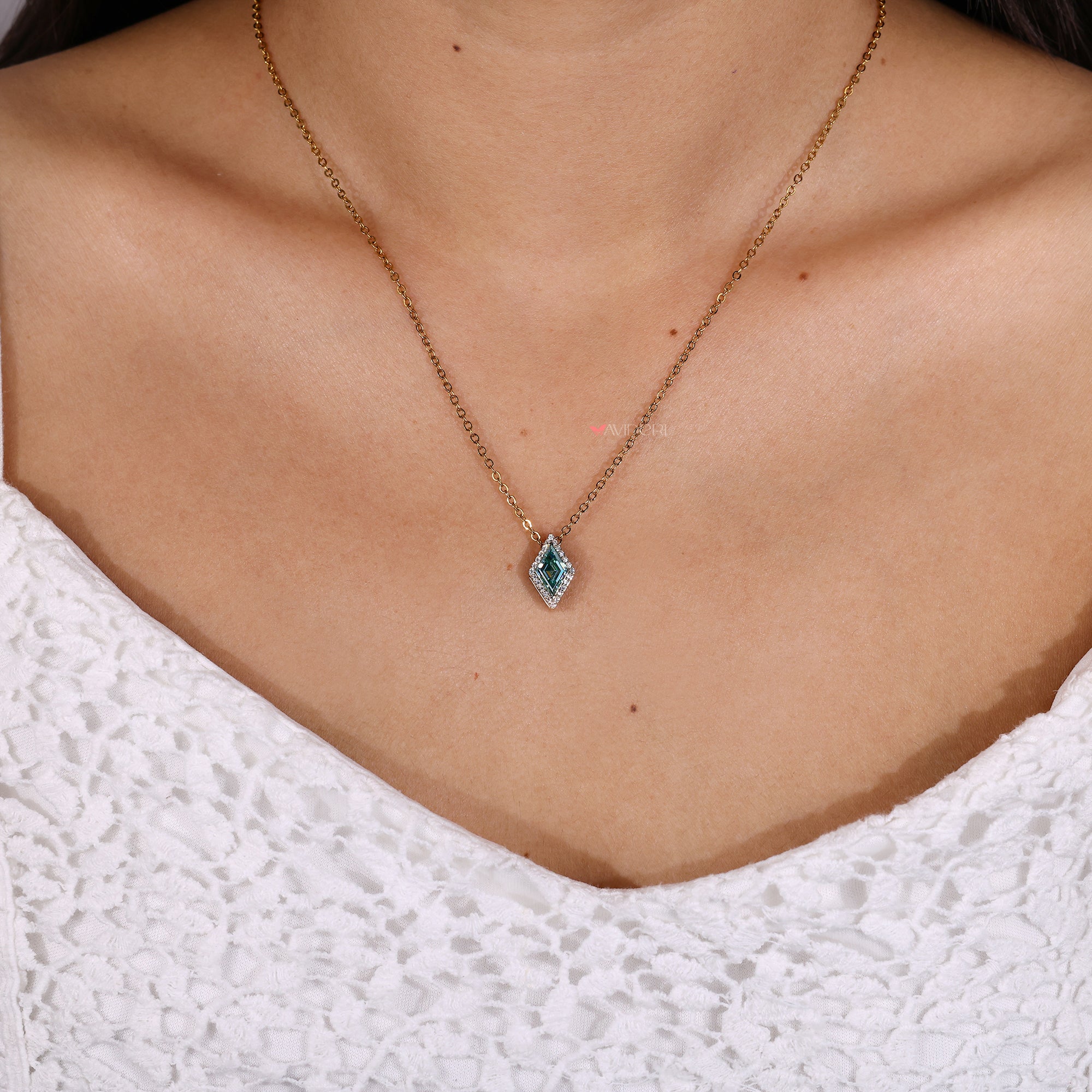 Cyan blue moissanite lozenge halo pendant.

