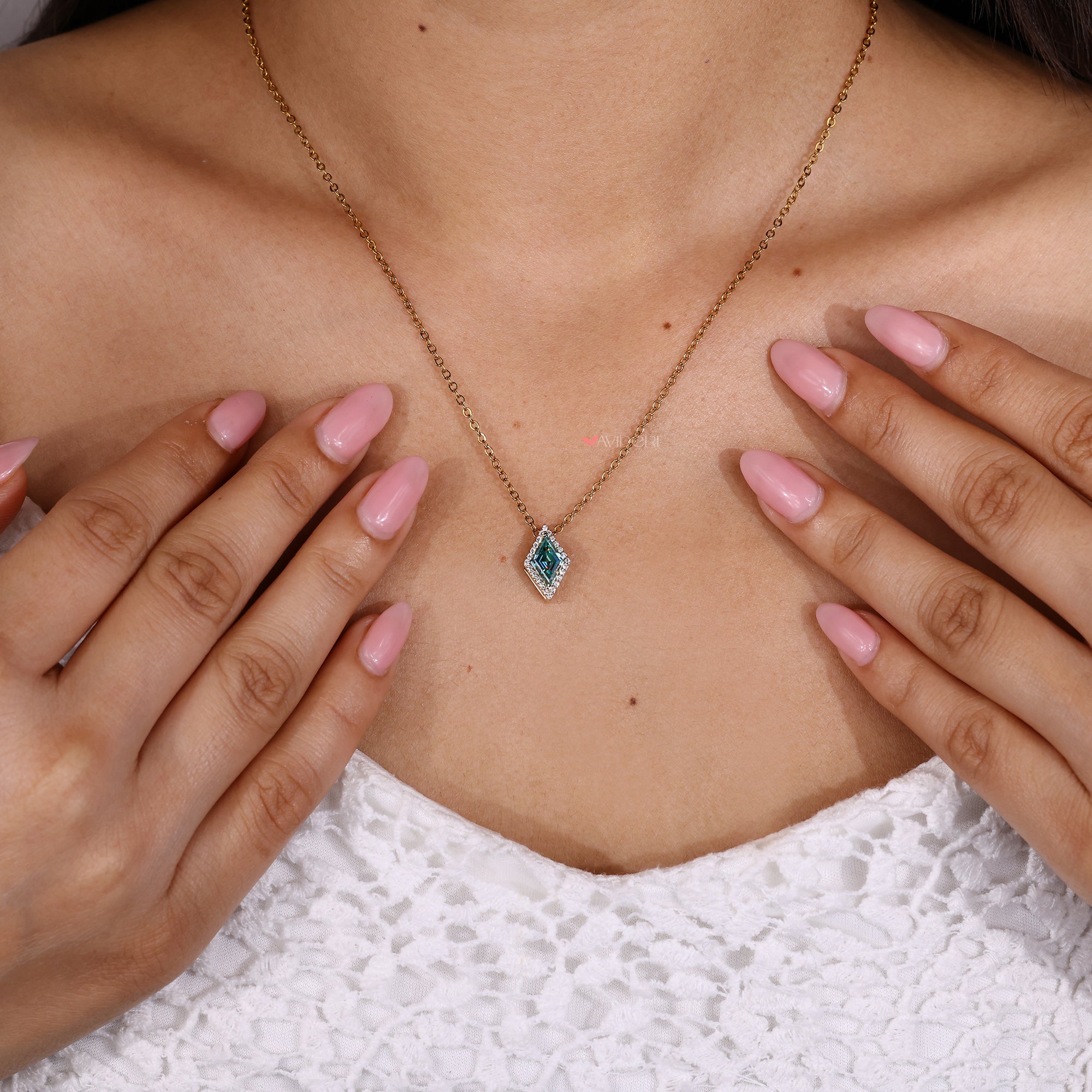 Lozenge pendant with round moissanite halo.

