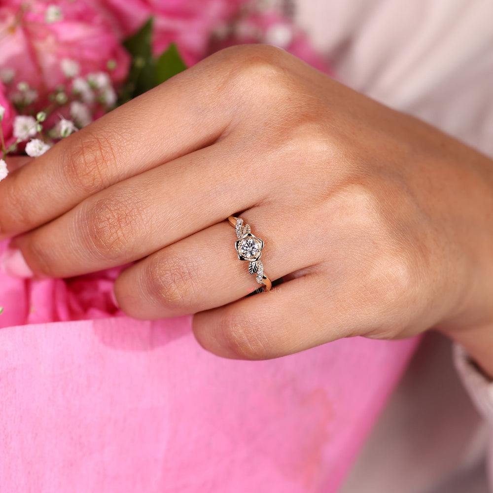 Elegant diamond ring featuring a round center stone in a flower-inspired setting.