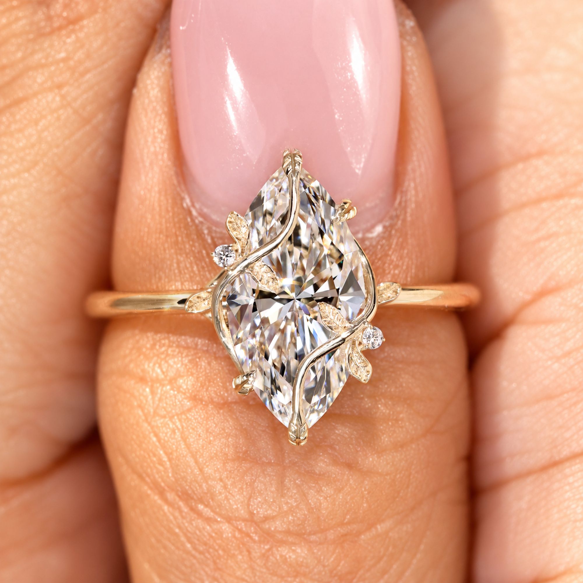 Marquise engagement ring with leaf style prong setting.
