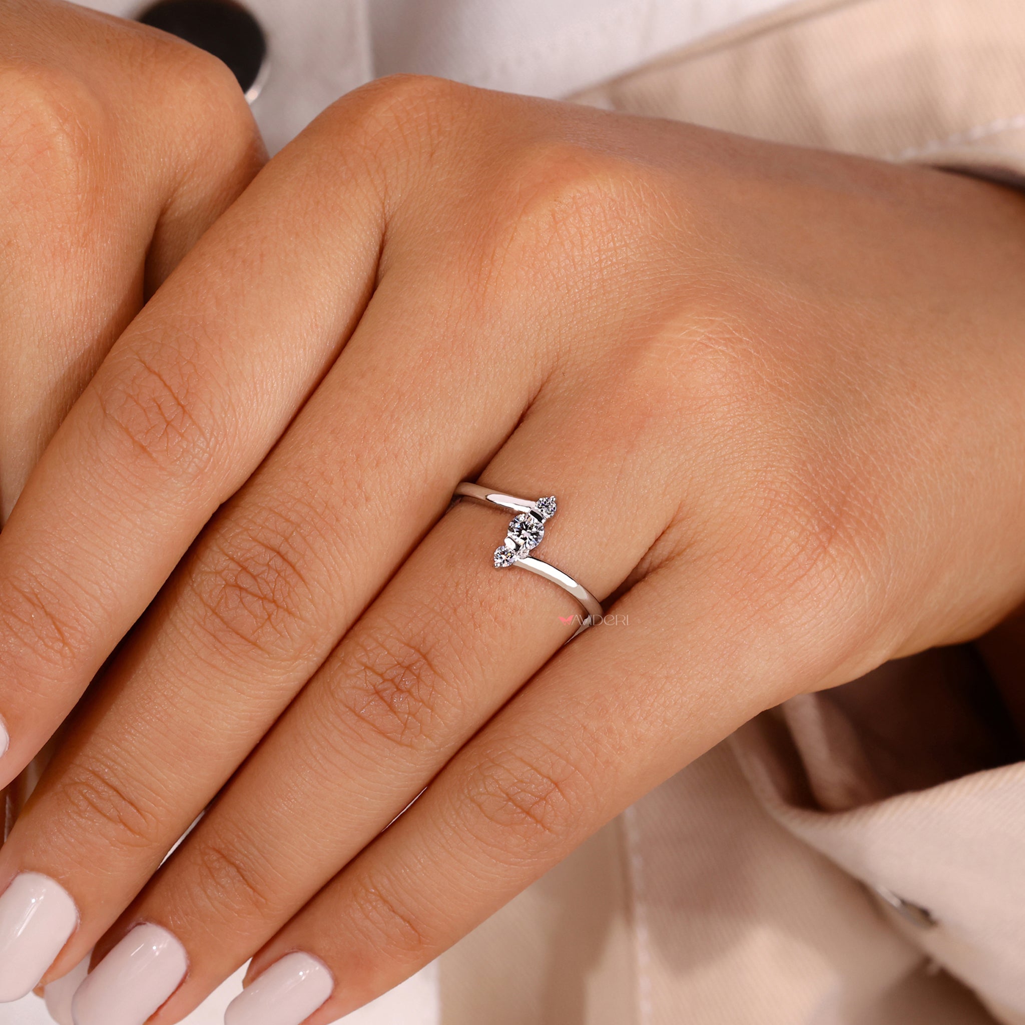 Three stone diamond ring with a white gold engagement ring.
