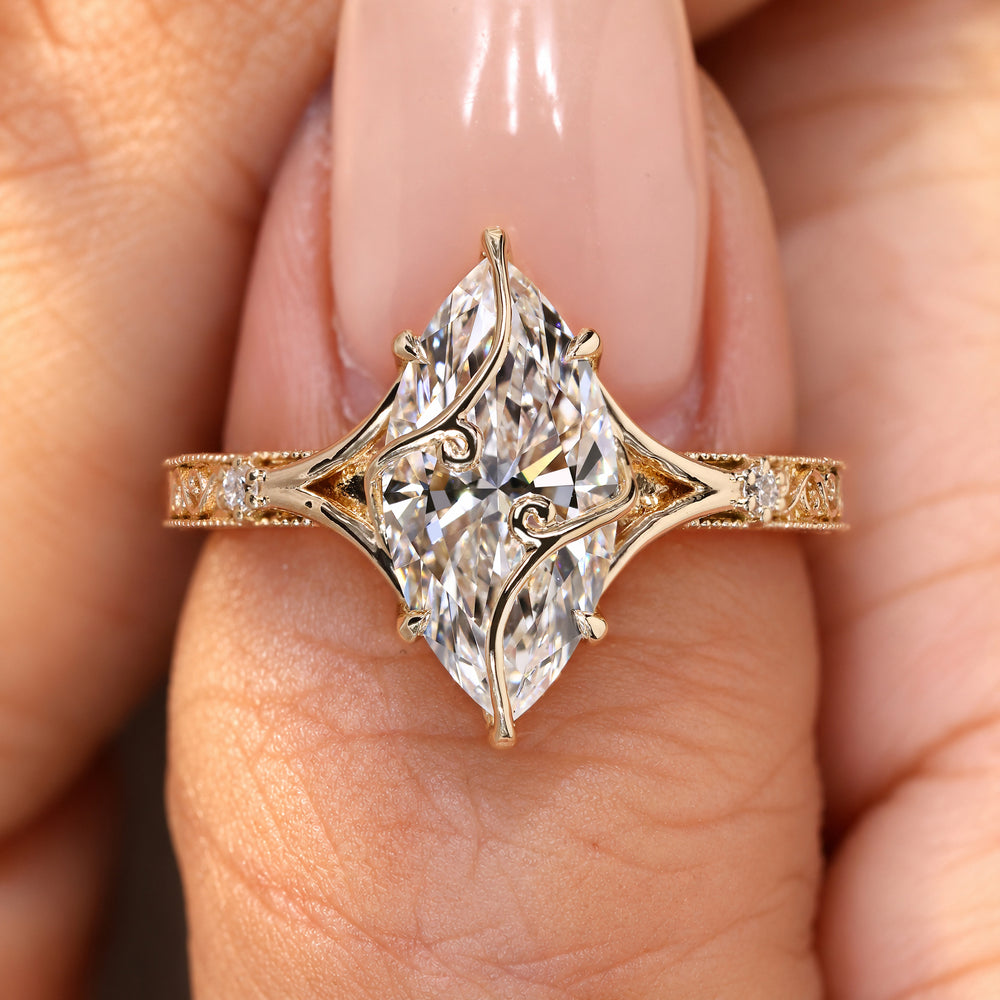 Marquise diamond ring with split shank design.
