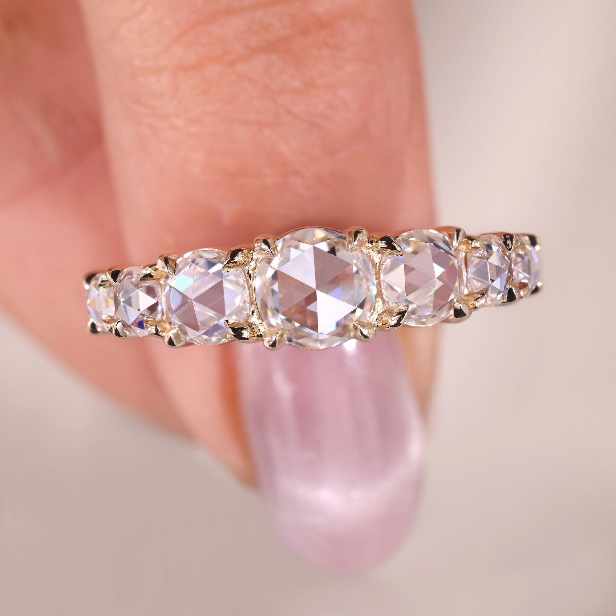 Half eternity band shines with diamonds across the top.
