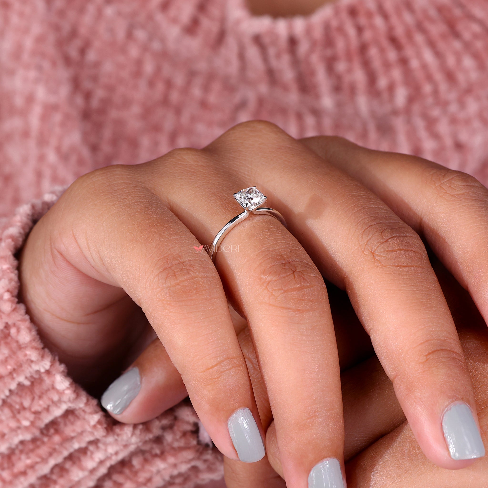 Cushion cut diamond solitaire ring in an elegant claw prong setting by Avideri.
