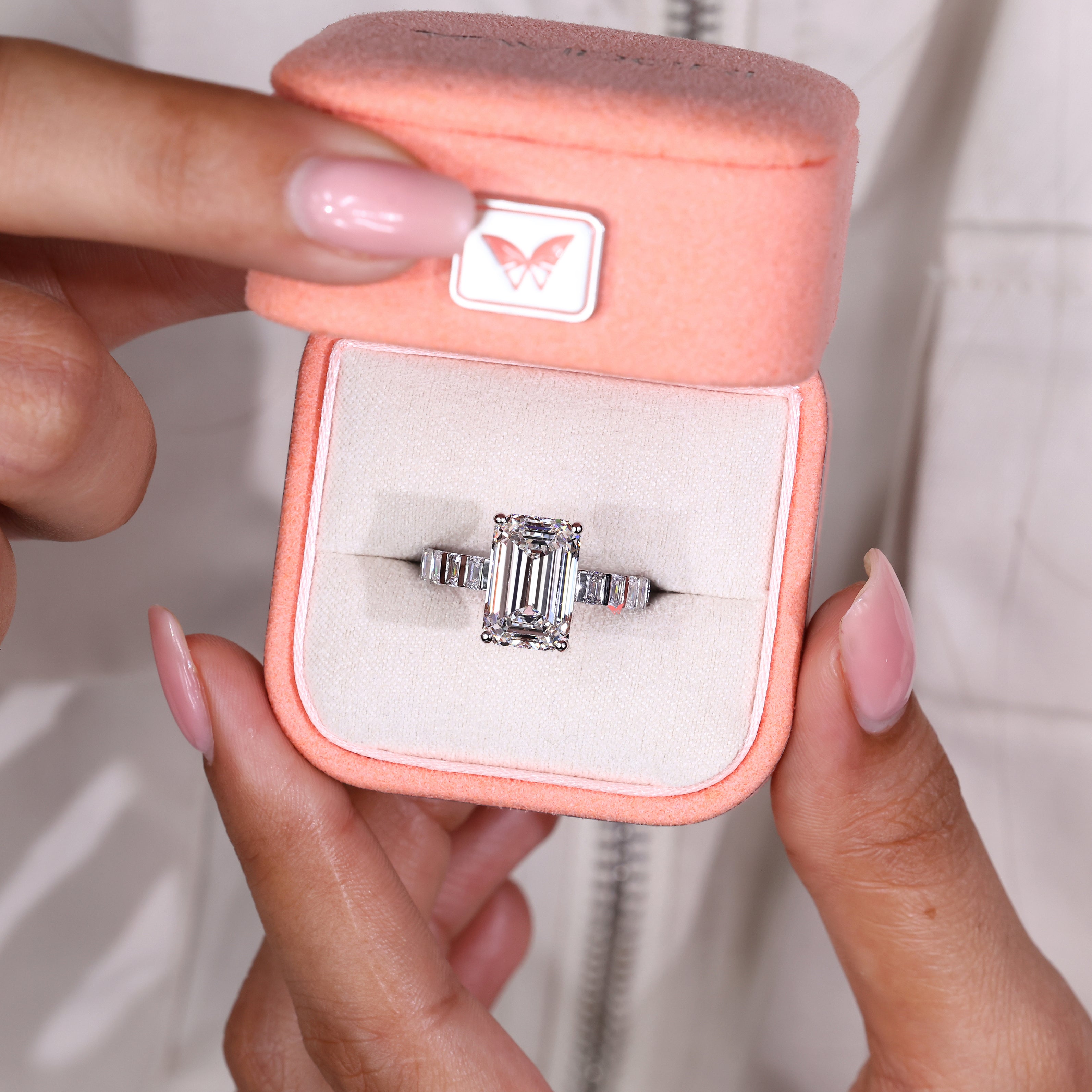 Emerald cut lab diamond ring with clean bar set accents

