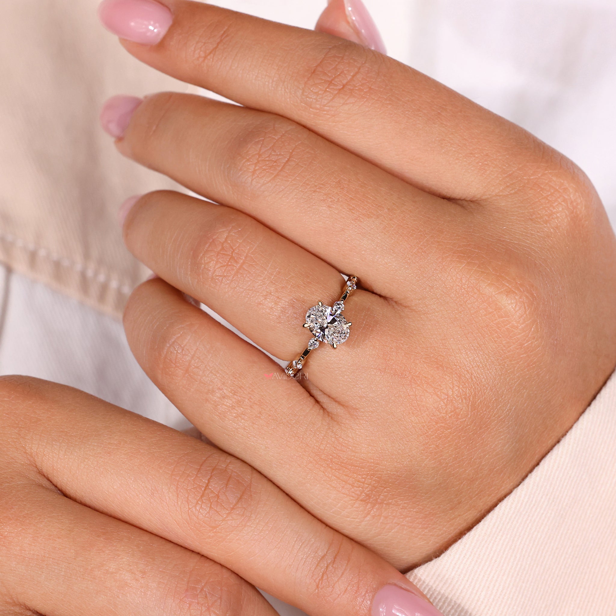 Oval ring showcasing an oval ring with diamonds and a distance pave ring for added sparkle and charm.
