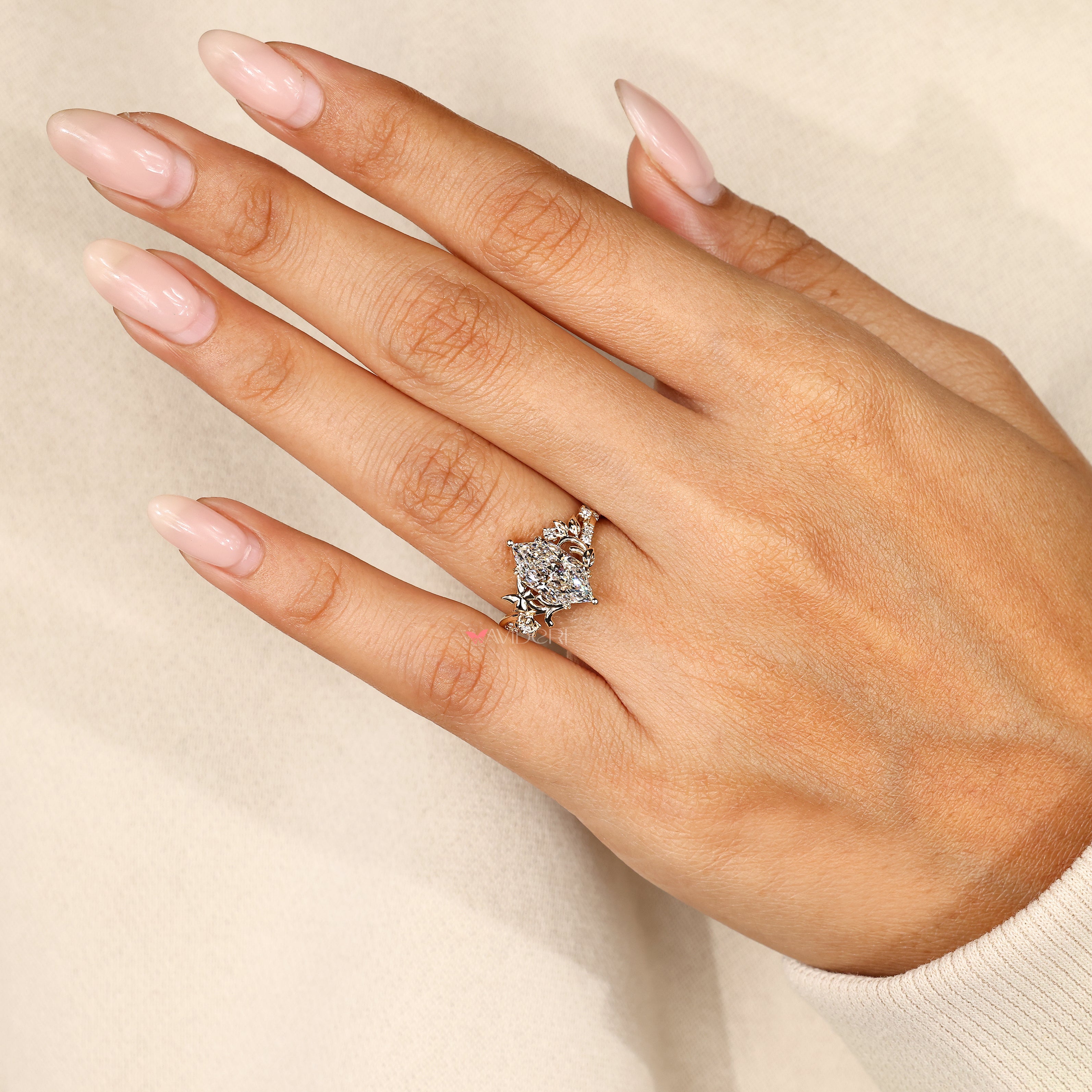 Butterfly style marquise diamond engagement ring.
