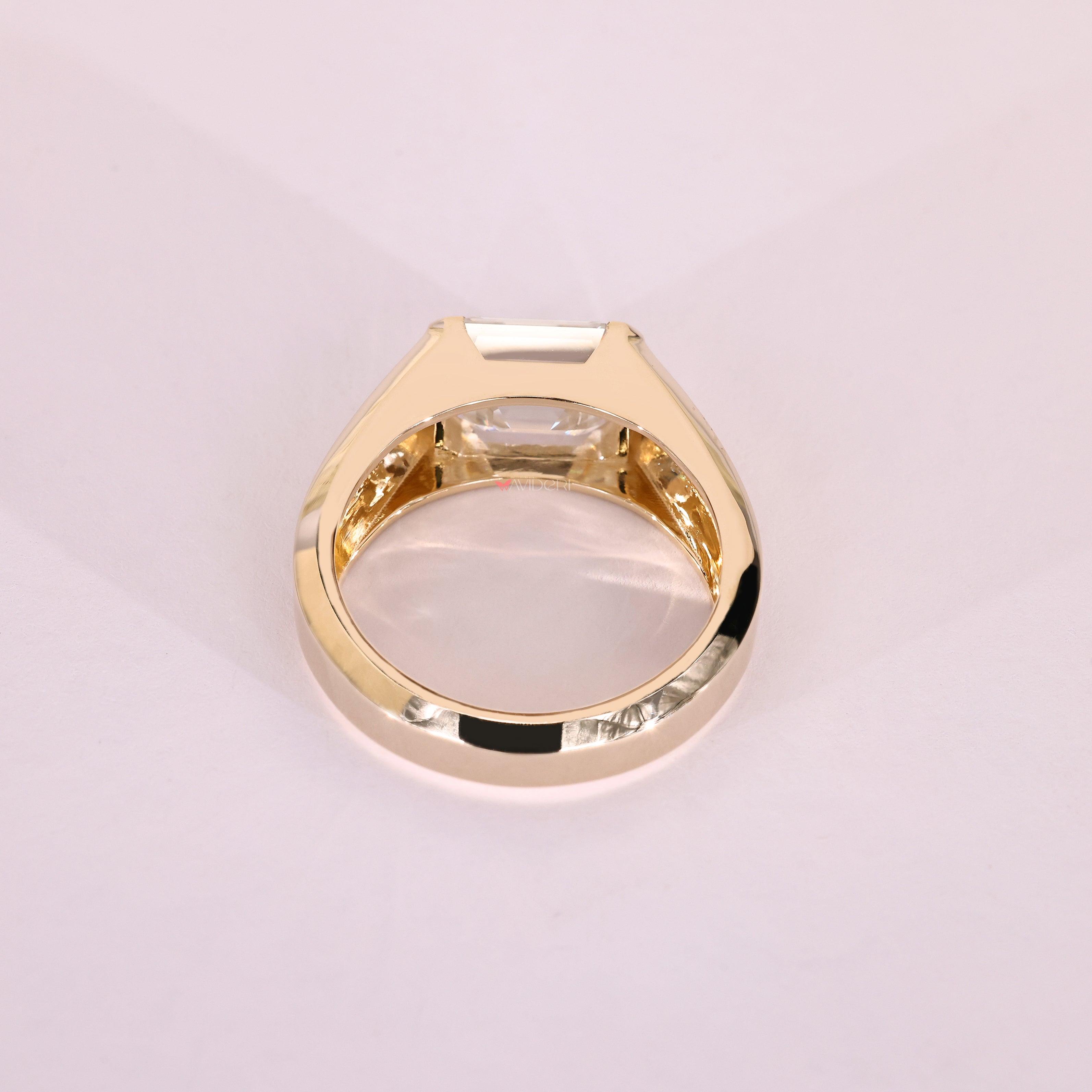 Tapered shank emerald moissanite men's ring.
